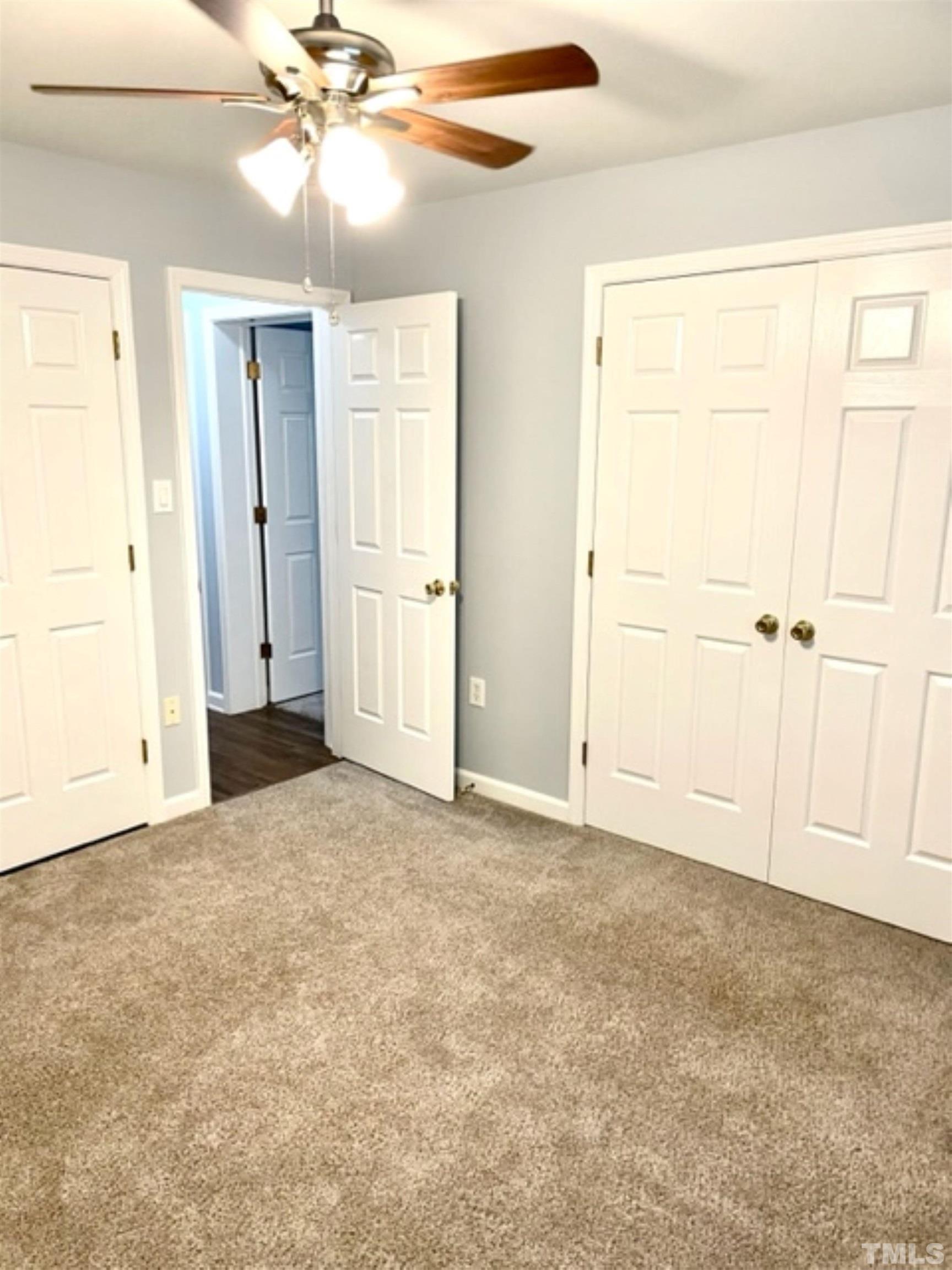 1323 Pointer Street Roxboro, NC 27573 - Photo 19 of 51 an empty room with closet and a chandelier fan