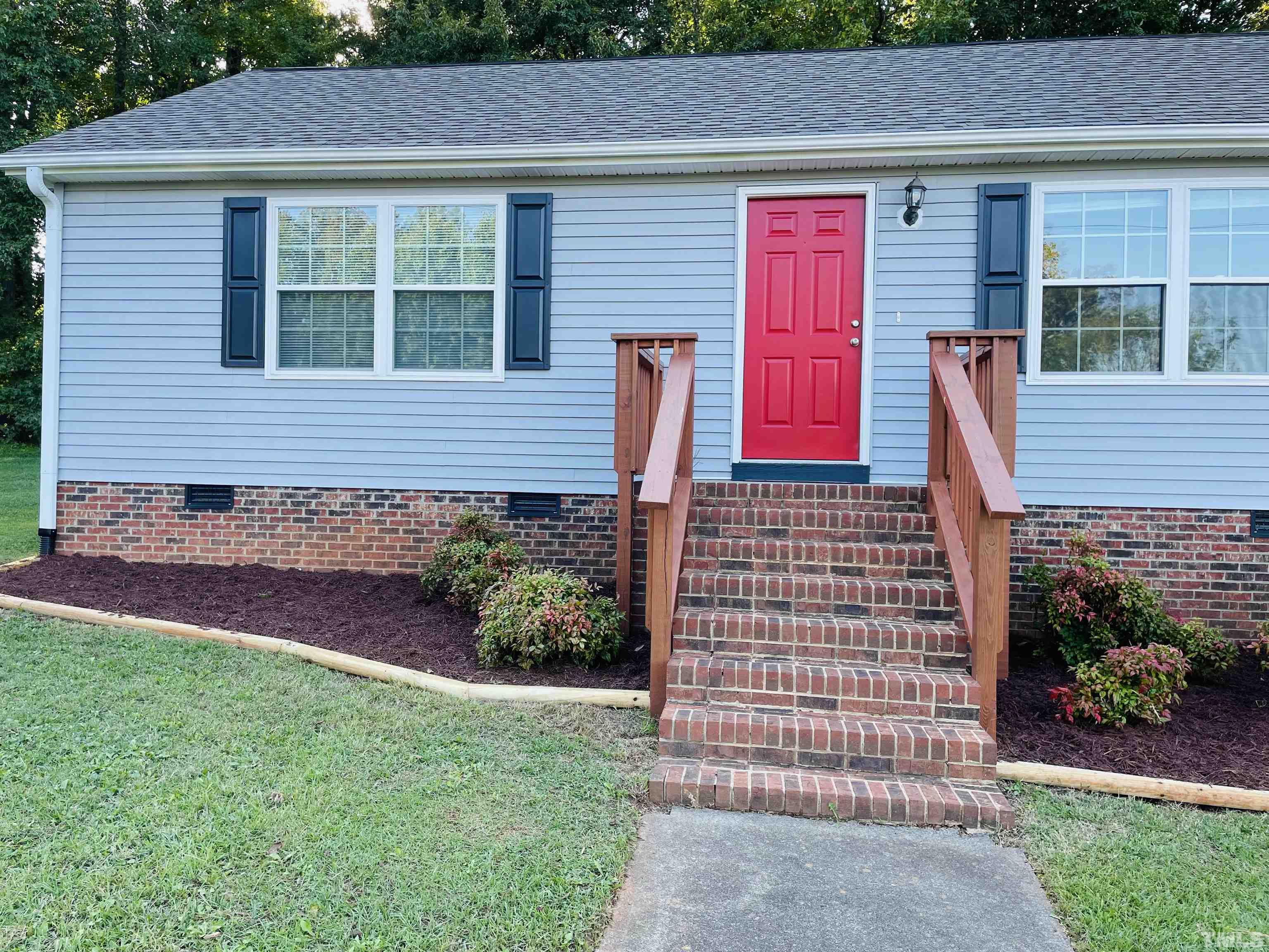 1323 Pointer Street Roxboro, NC 27573 - Photo 2 of 51 a front view of a house with a garden