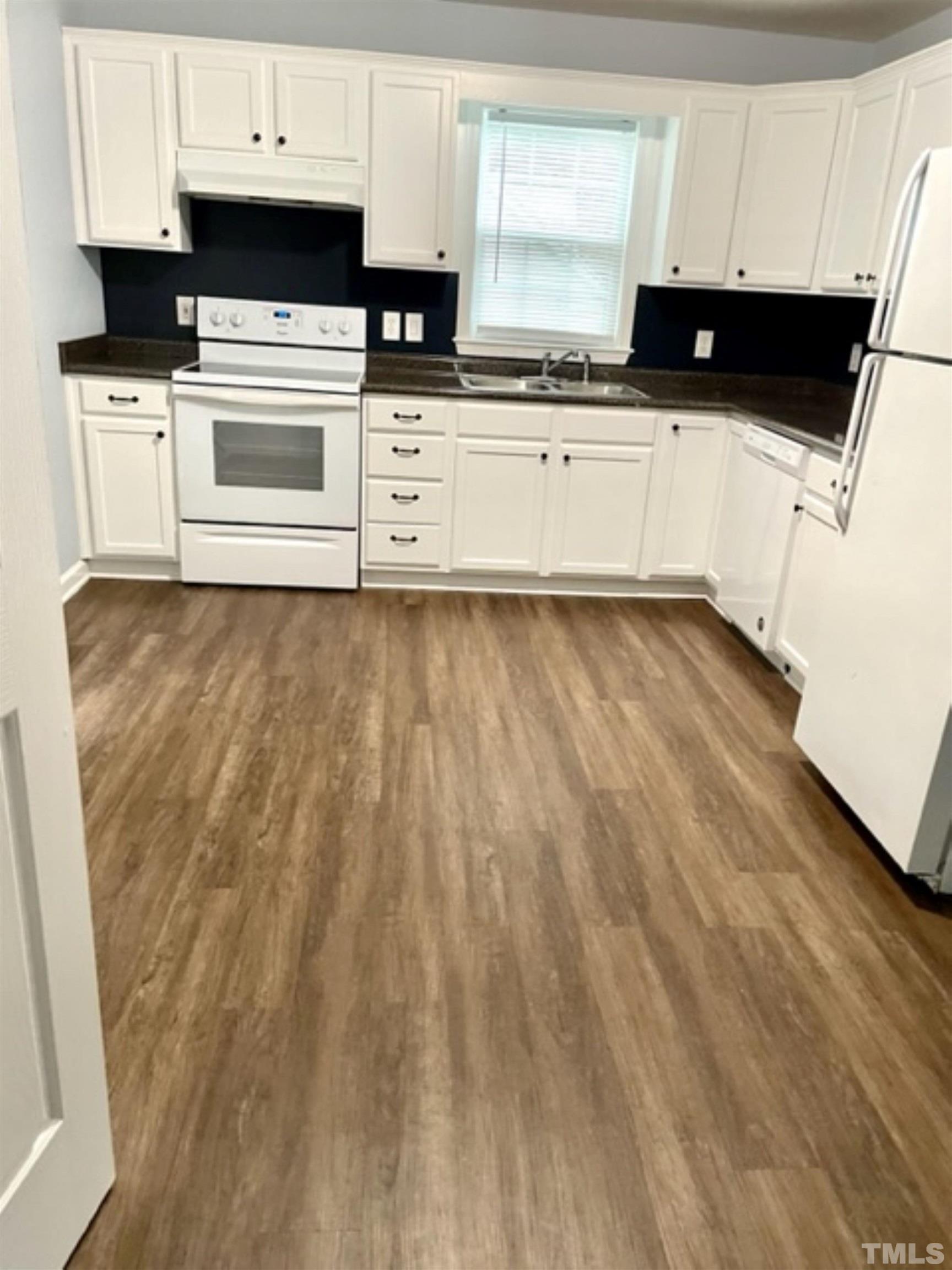 1323 Pointer Street Roxboro, NC 27573 - Photo 38 of 51 a kitchen with wooden cabinets and black appliances