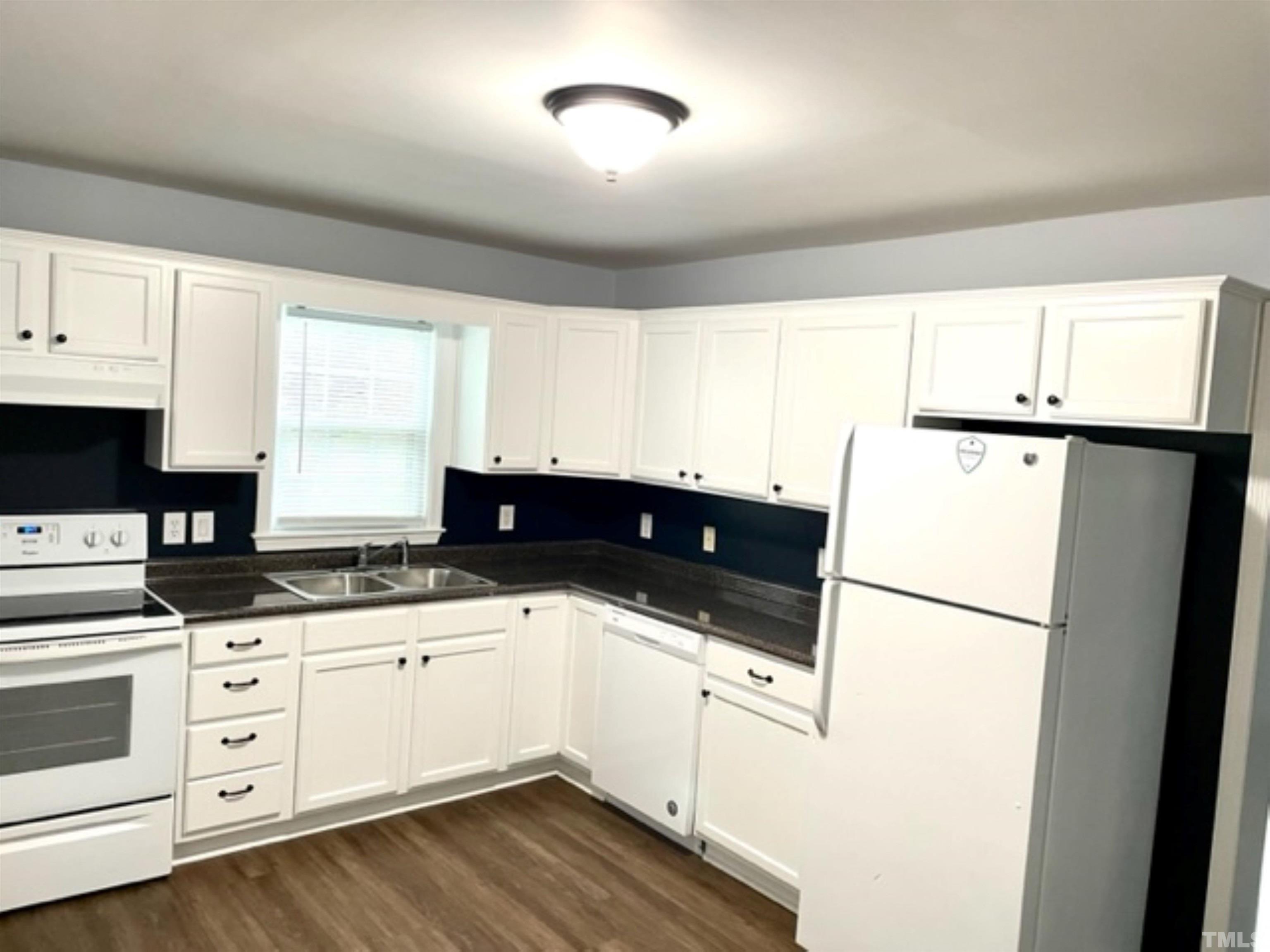 1323 Pointer Street Roxboro, NC 27573 - Photo 7 of 51 a kitchen with granite countertop white cabinets and white appliances