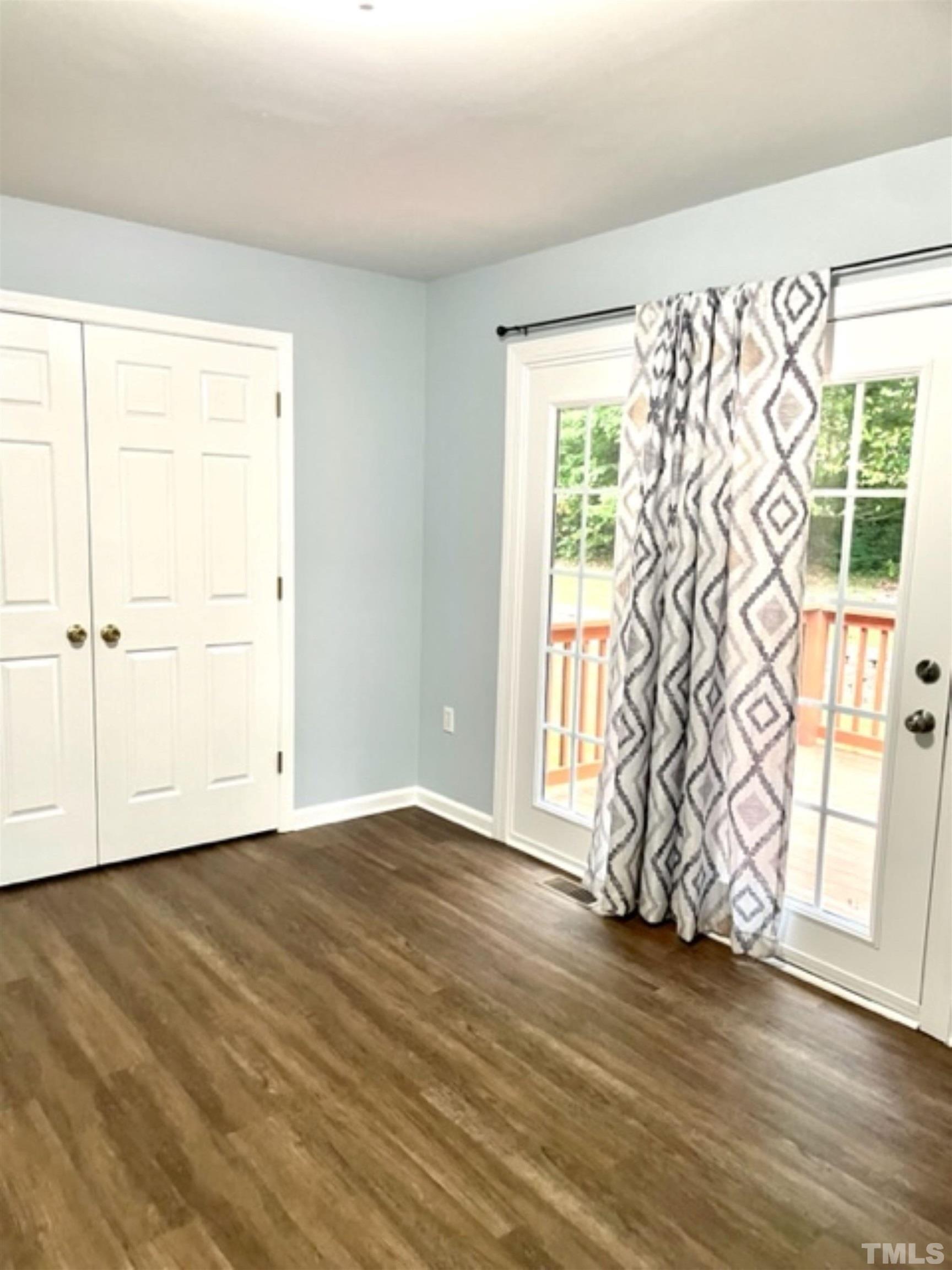 1323 Pointer Street Roxboro, NC 27573 - Photo 10 of 51 an empty room with wooden floor and a window