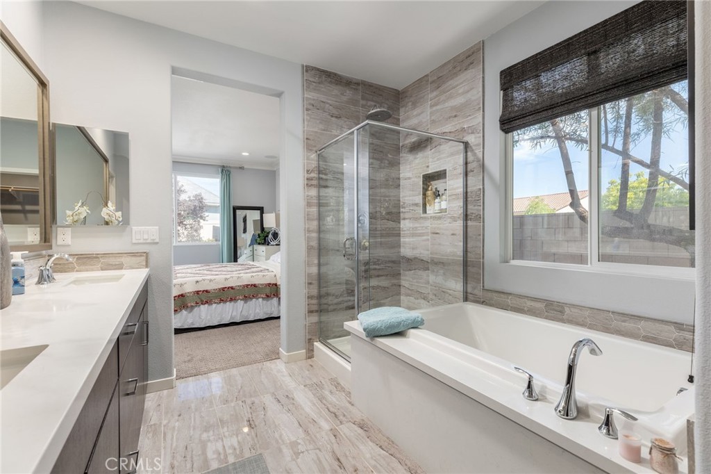 31094 Branches Circle Winchester, CA 92596 - Photo 14 of 32 a bathroom with a tub sink and double vanity