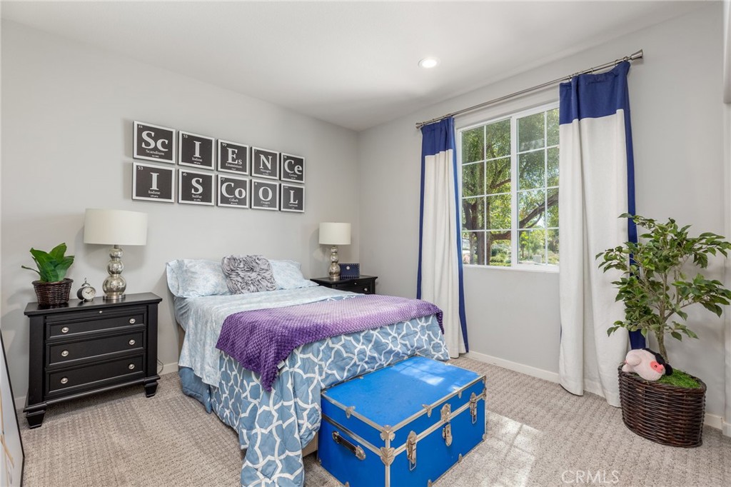 31094 Branches Circle Winchester, CA 92596 - Photo 15 of 32 a bedroom with a bed and a potted plant