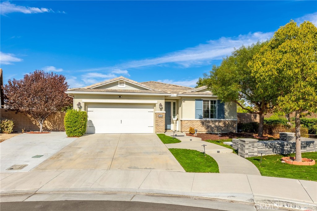 31094 Branches Circle Winchester, CA 92596 - Photo 2 of 32 a front view of a house with a yard and garage