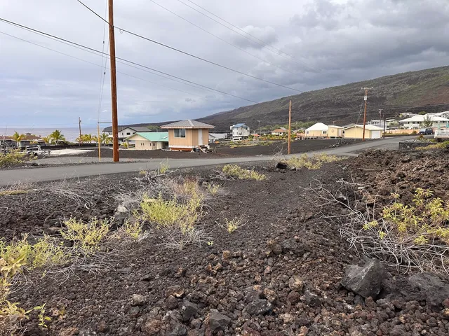a view of a big yard with wooden fence