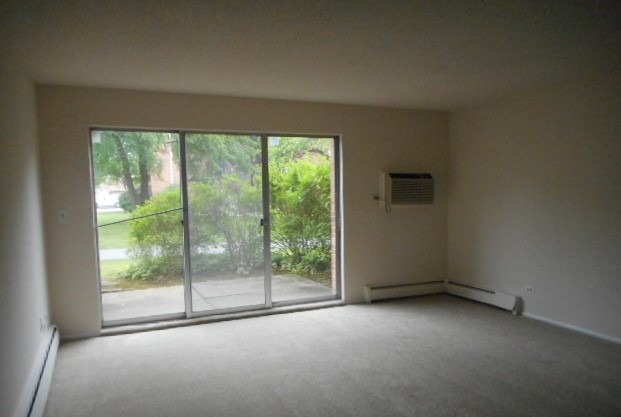 1117 South Old Wilke Road, Unit 106 Rolling Meadows, IL 60005 - Photo 3 of 13 a view of room with window and floor to ceiling window
