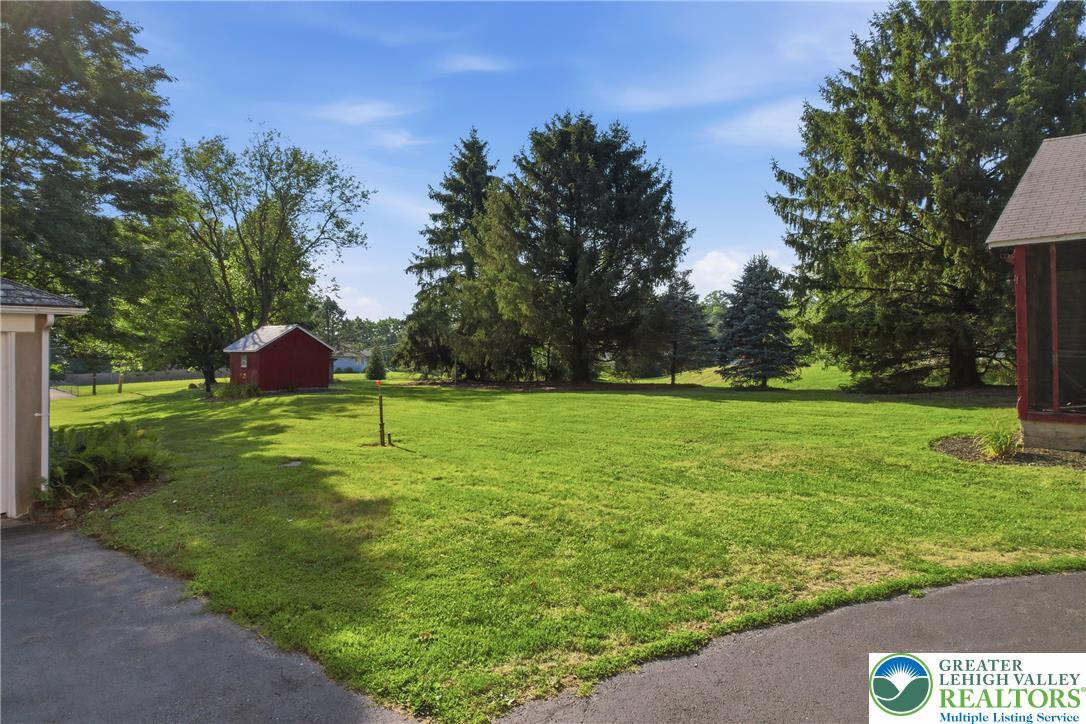4682 Steuben Road Bethlehem, PA 18020 - Photo 66 of 79 A verdant backyard with mature evergreens and a charming storage shed.