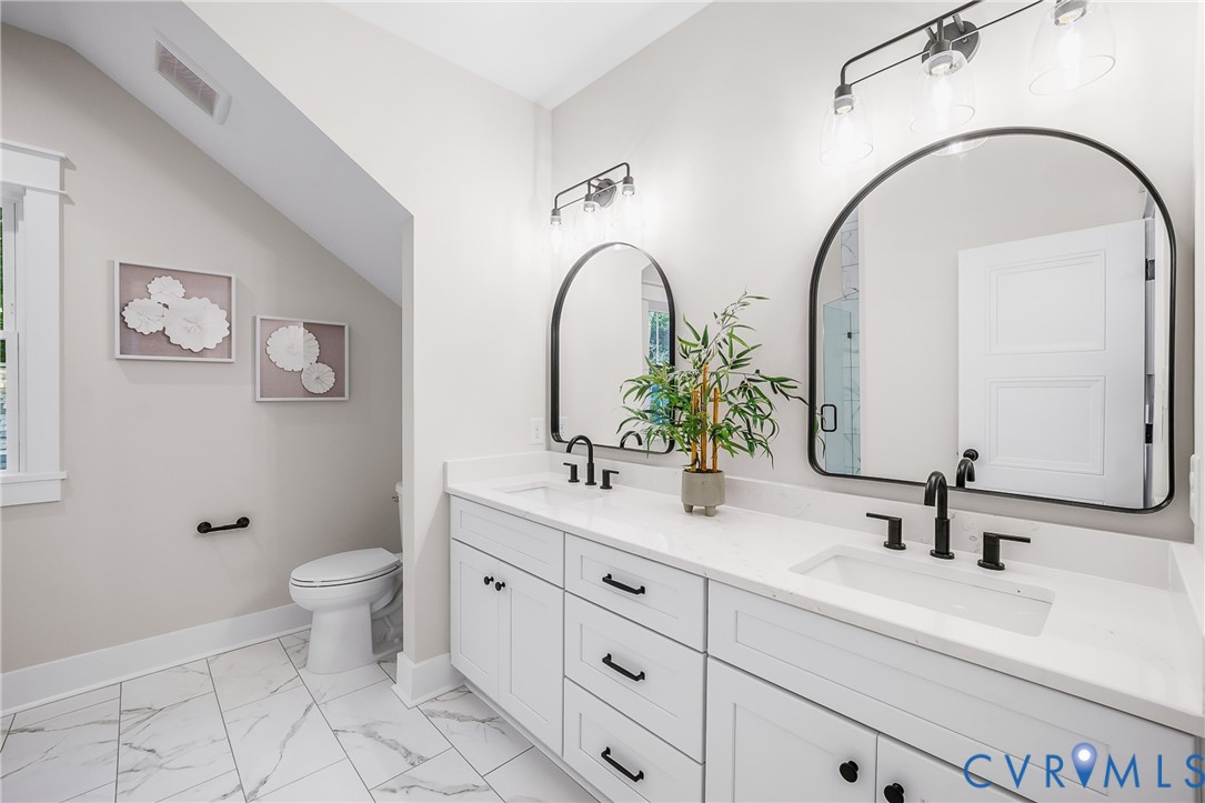 8299 Pamlico Road Ashland, VA 23005 - Photo 30 of 35 a bathroom with a double vanity sink toilet and a mirror