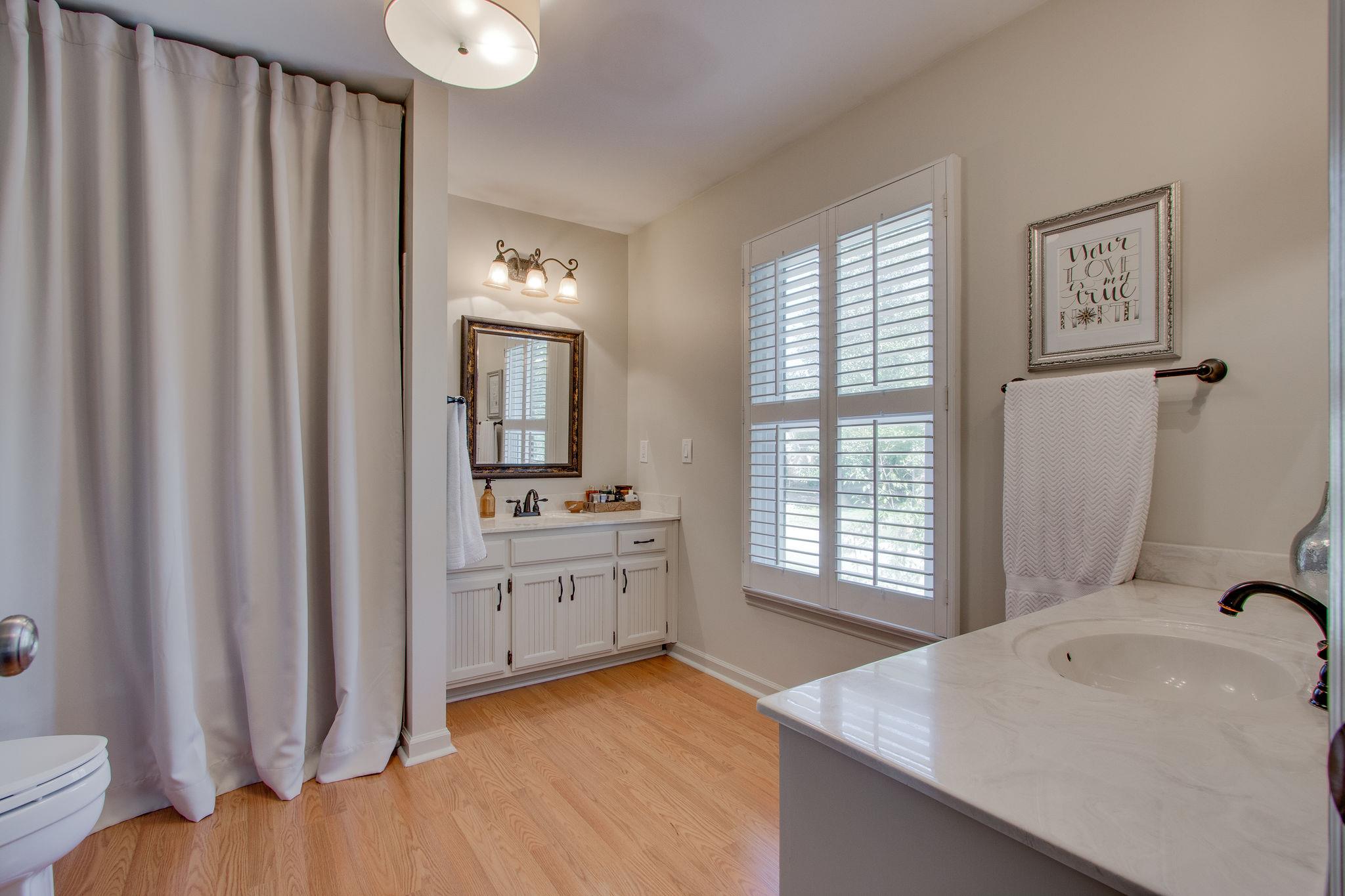 209 Cherokee Road Nashville, TN 37205 - Photo 19 of 25 Master bath with two vanities and tub/shower combination