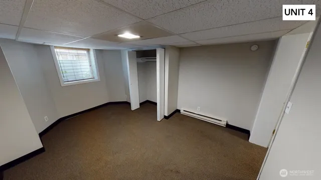 a white house covered with tall trees