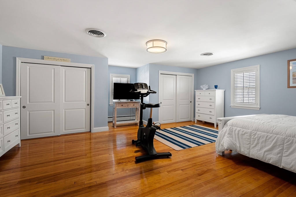 4 Dean Road Marblehead, MA 01945 - Photo 18 of 38 a bedroom with furniture and a wooden floor