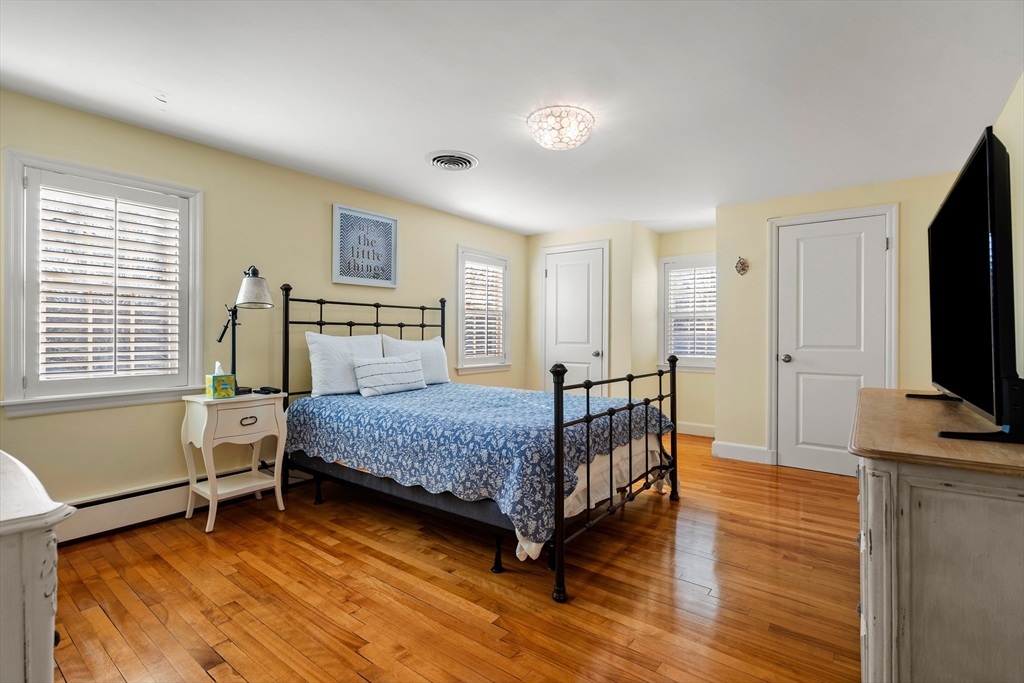 4 Dean Road Marblehead, MA 01945 - Photo 22 of 38 a bedroom with a bed and a flat tv screen on the dresser