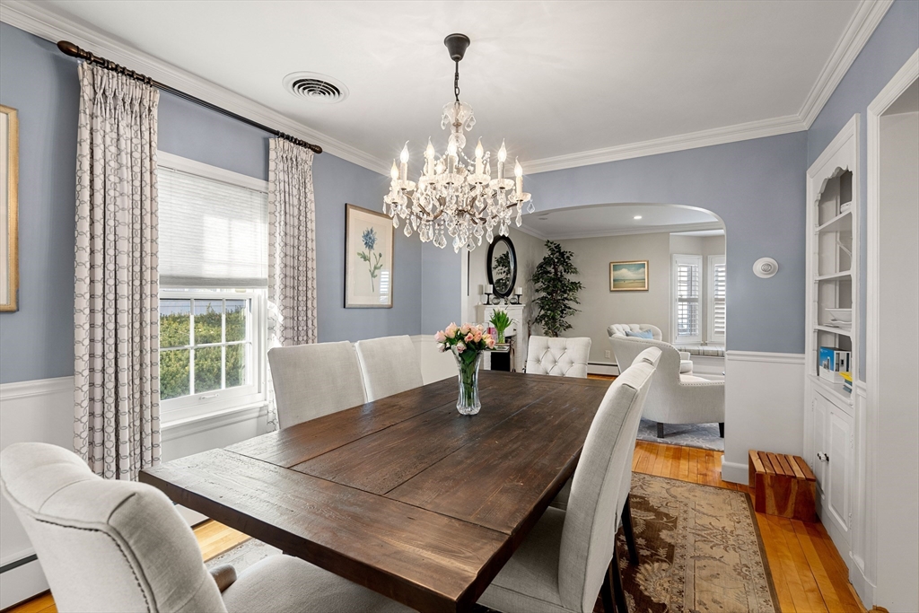 4 Dean Road Marblehead, MA 01945 - Photo 6 of 38 a dining room with wooden floor a chandelier a wooden table and chairs