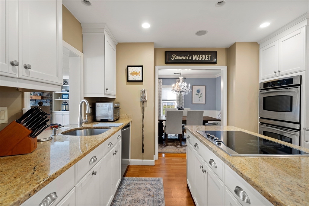 4 Dean Road Marblehead, MA 01945 - Photo 9 of 38 a large kitchen with stainless steel appliances granite countertop a lot of counter space and wooden floor