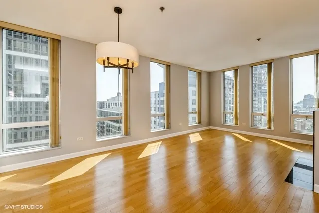 a view of an room with wooden floor and windows