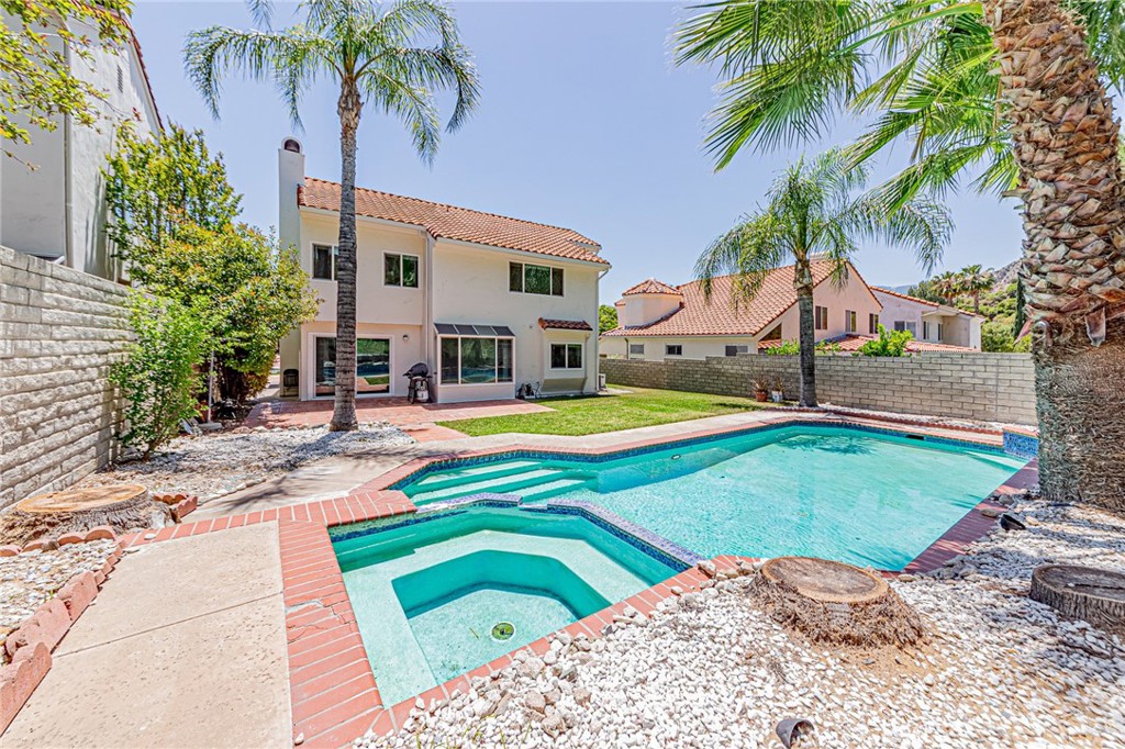 25533 Longfellow Place Stevenson Ranch, CA 91381 - Photo 34 of 47 a view of swimming pool with lawn chairs and plants
