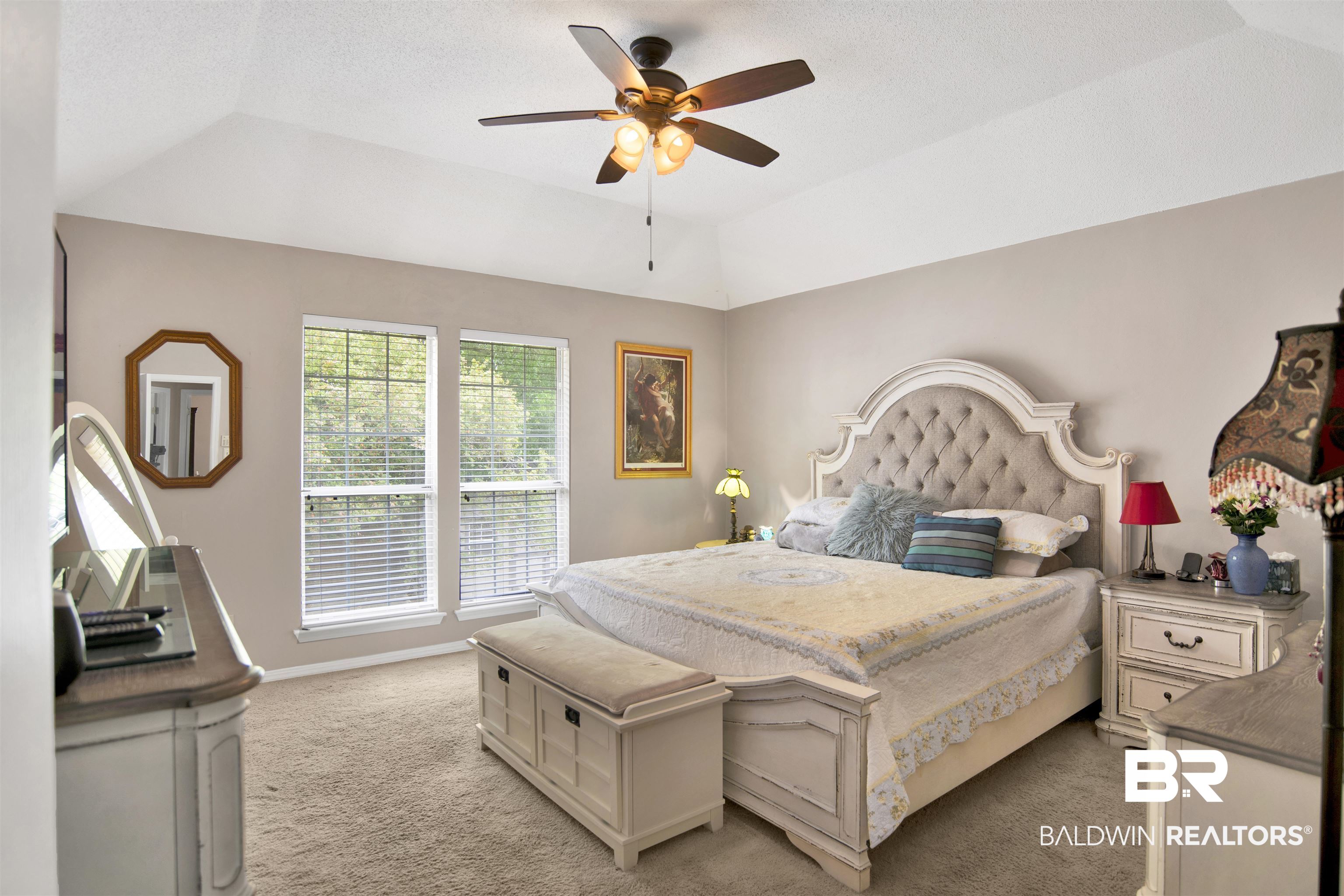 107 Virginia Circle Daphne, AL 36526 - Photo 17 of 47 Room featuring a vaulted ceiling with a ceiling fan, dual windows, and wall-to-wall carpeting