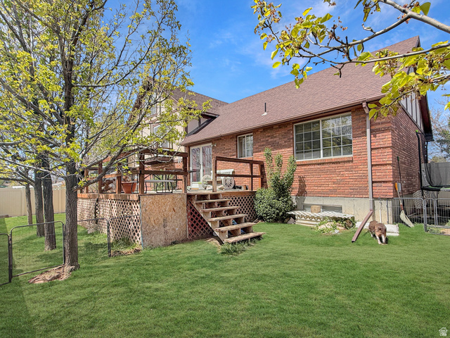1716 Sagewood Road Price, UT 84501 - Photo 47 of 73 Back of house with a wooden deck, brick siding, and roof with shingles