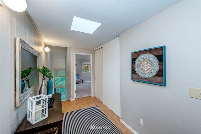 a bedroom with a bed and a painting on the wall