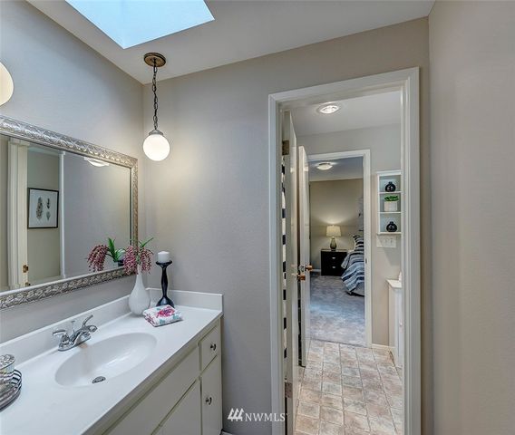 a en suite bathroom with a sink mirror and shower