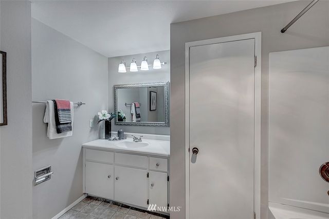 a bathroom with a sink vanity and mirror