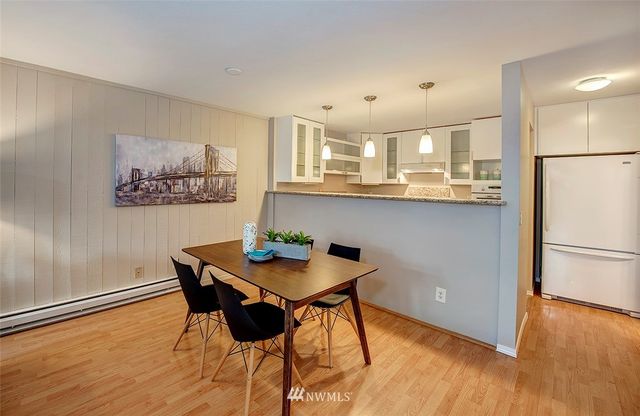 a view of a kitchen with furniture and wooden floor
