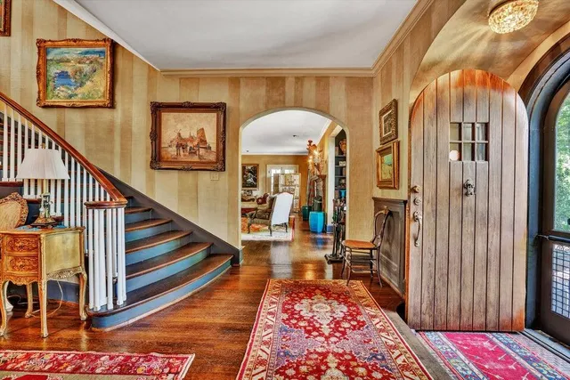 a living room with furniture and a floor to ceiling window