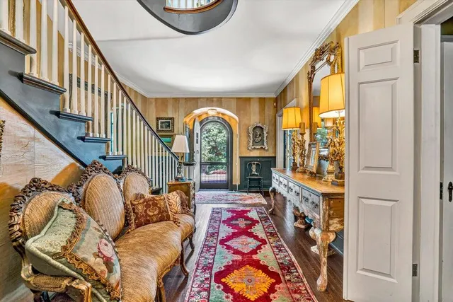 a living room with furniture and a floor to ceiling window