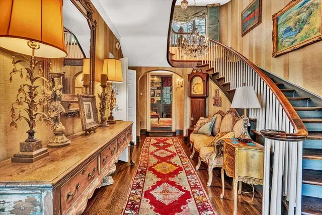 a living room with furniture a rug and a fireplace