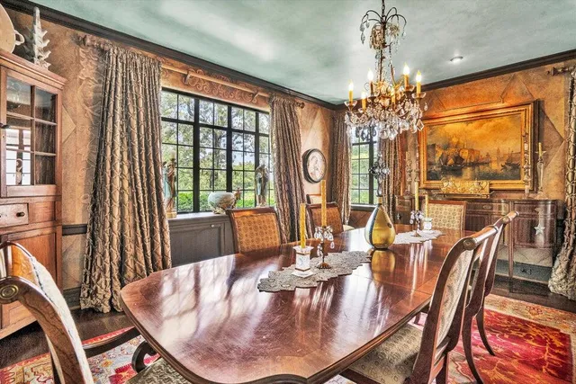 a living room with furniture a rug and a painting on the wall