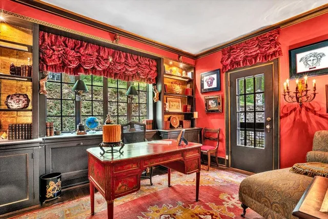 a living room with furniture fireplace and a large window