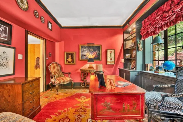 a living room with furniture fireplace and a large window