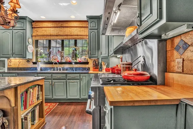 a large bedroom with a bed and wooden floor