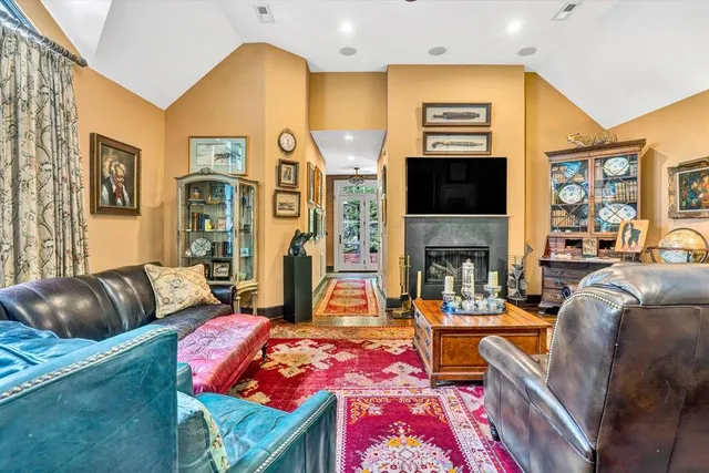 a bedroom with a bed a bookshelf and a large window