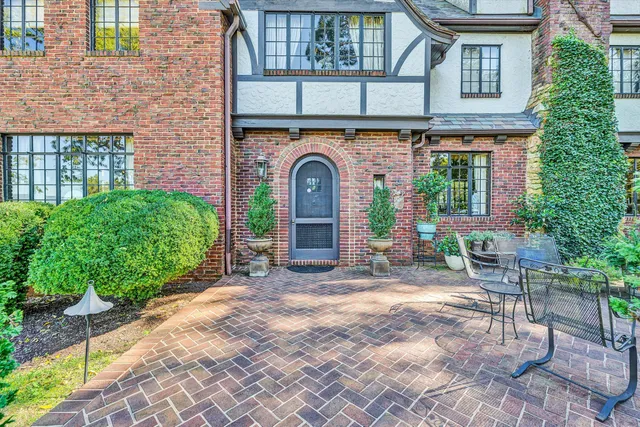 a living room with furniture fireplace and a large window