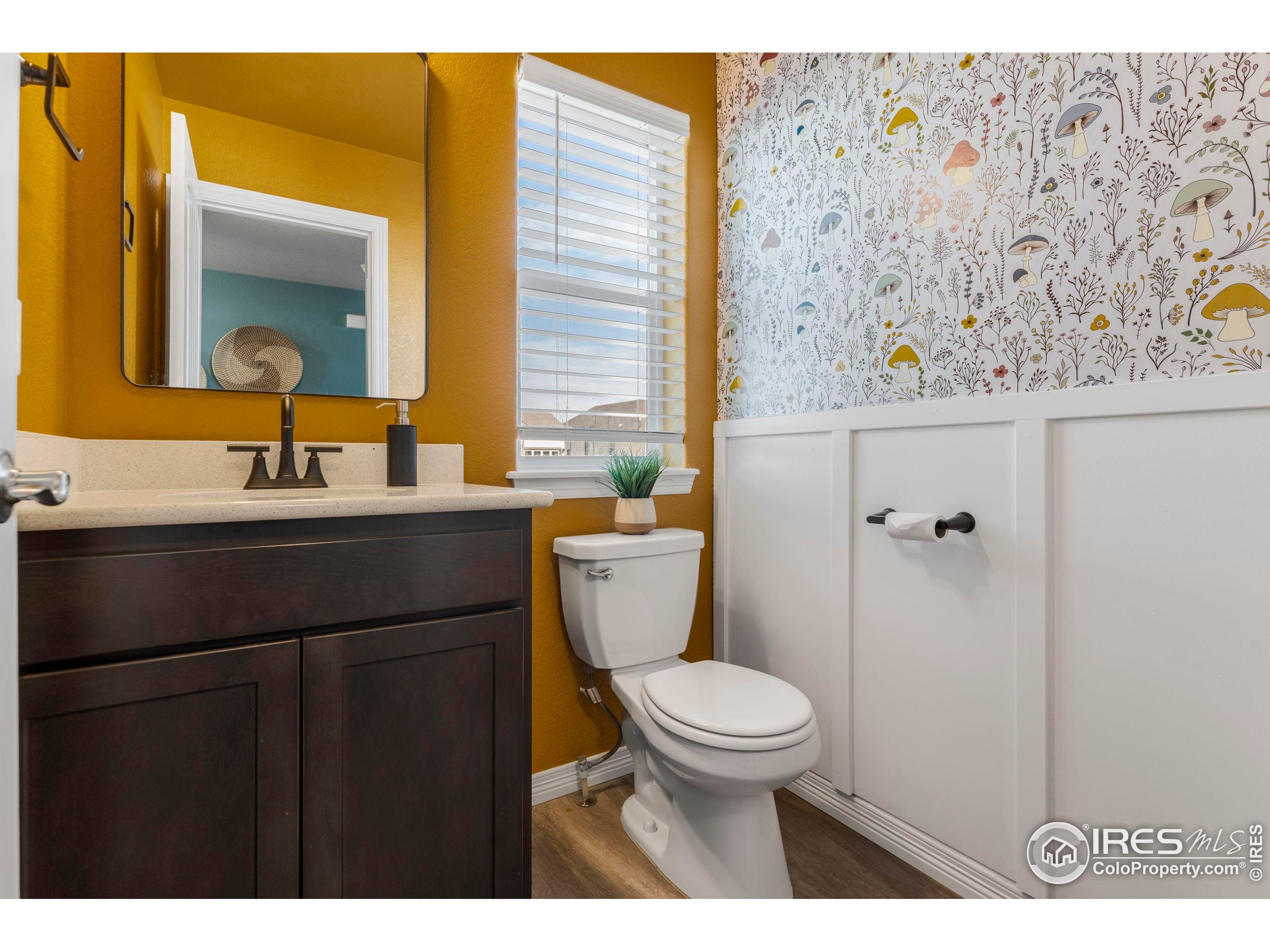 4527 Longmead Drive Windsor, CO 80550 - Photo 12 of 32 a bathroom with a toilet sink and mirror