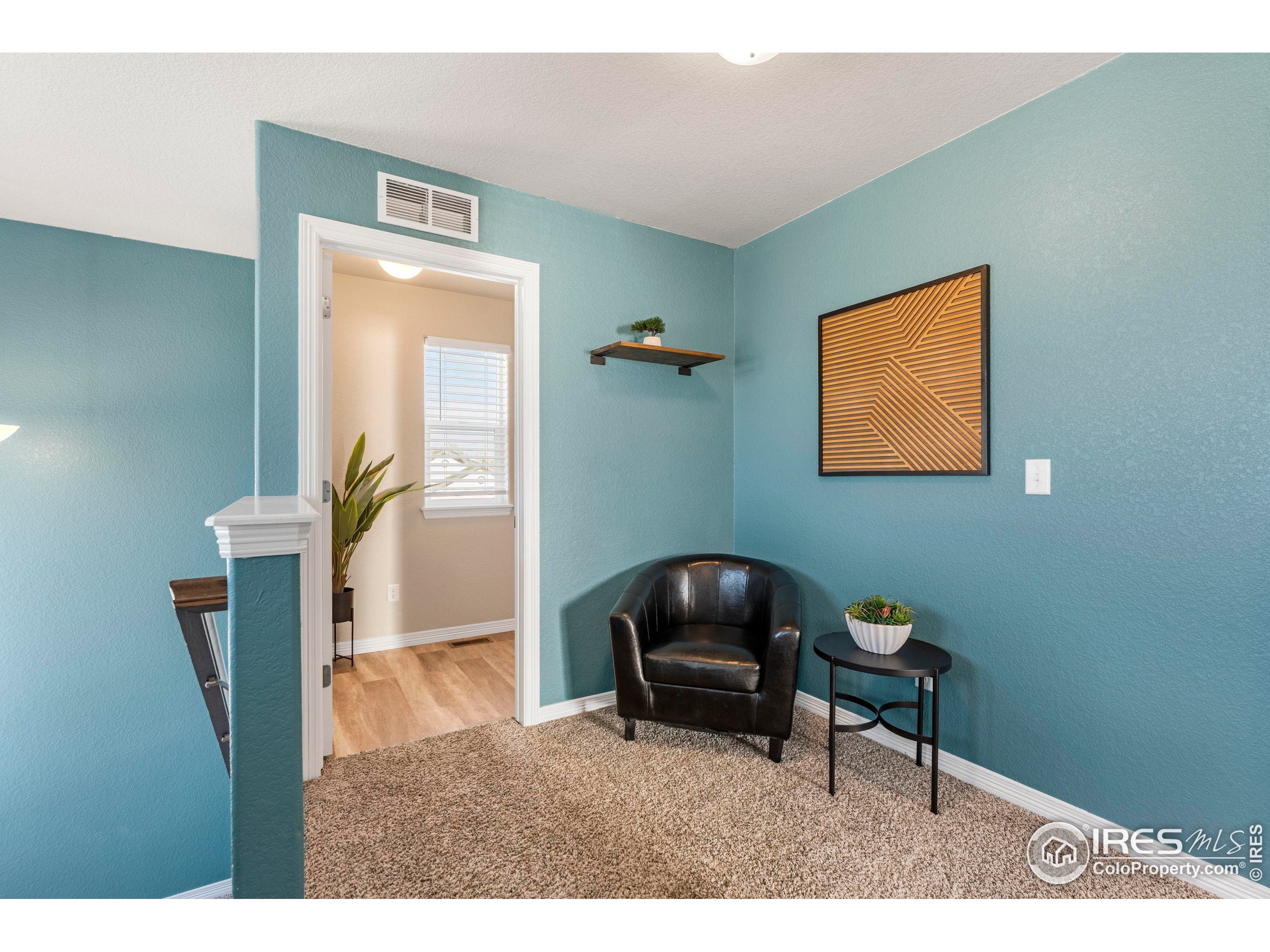 4527 Longmead Drive Windsor, CO 80550 - Photo 13 of 32 a living room with furniture and a chair