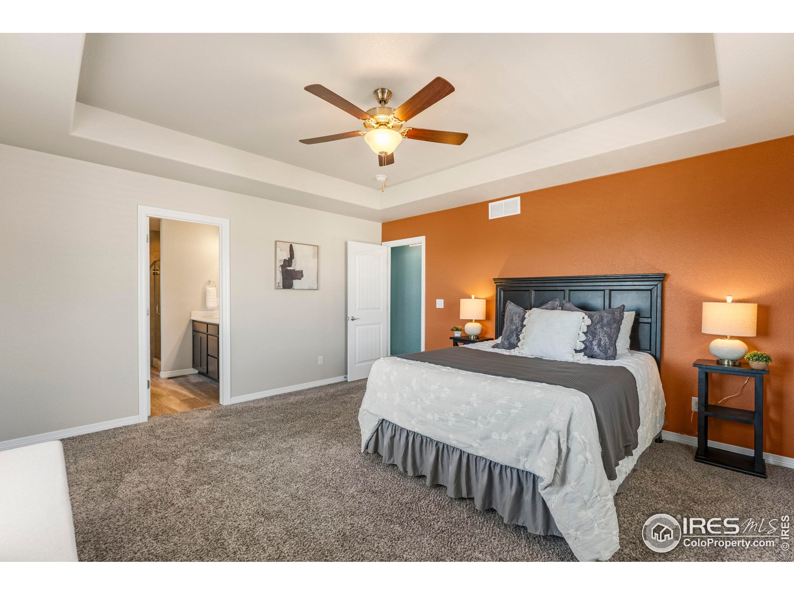 4527 Longmead Drive Windsor, CO 80550 - Photo 16 of 32 a bedroom with a bed and ceiling fan