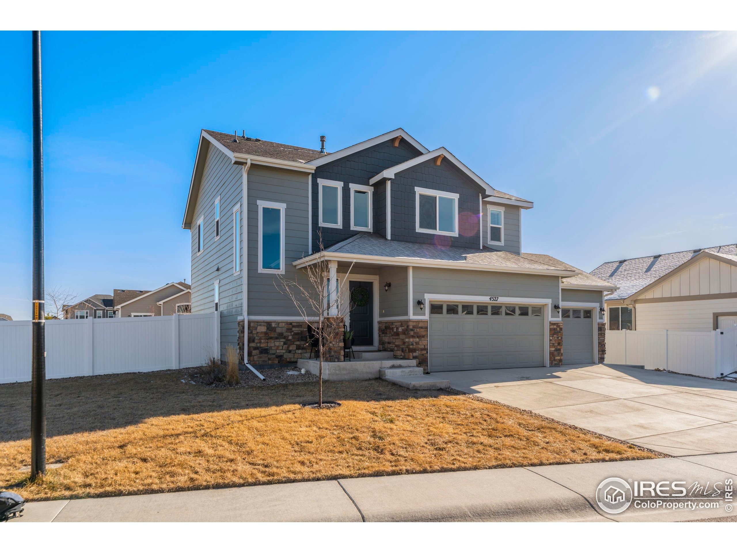 4527 Longmead Drive Windsor, CO 80550 - Photo 2 of 32 a front view of a house with a yard