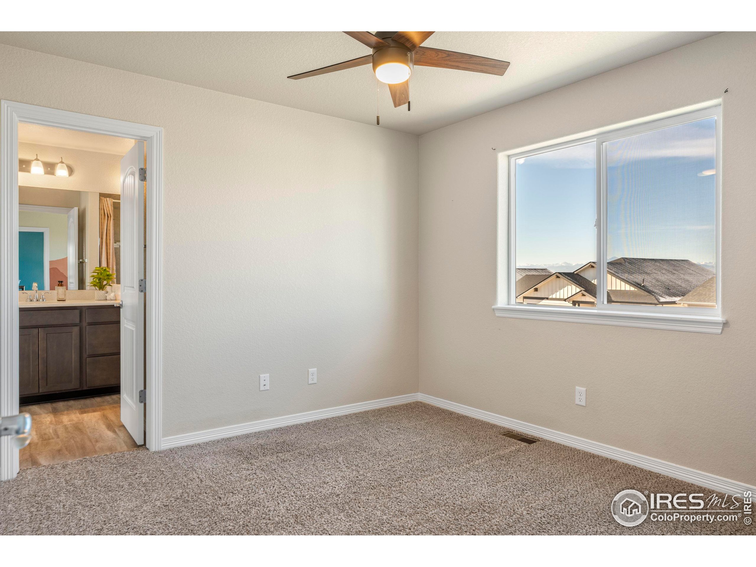 4527 Longmead Drive Windsor, CO 80550 - Photo 23 of 32 a view of an empty room with a window