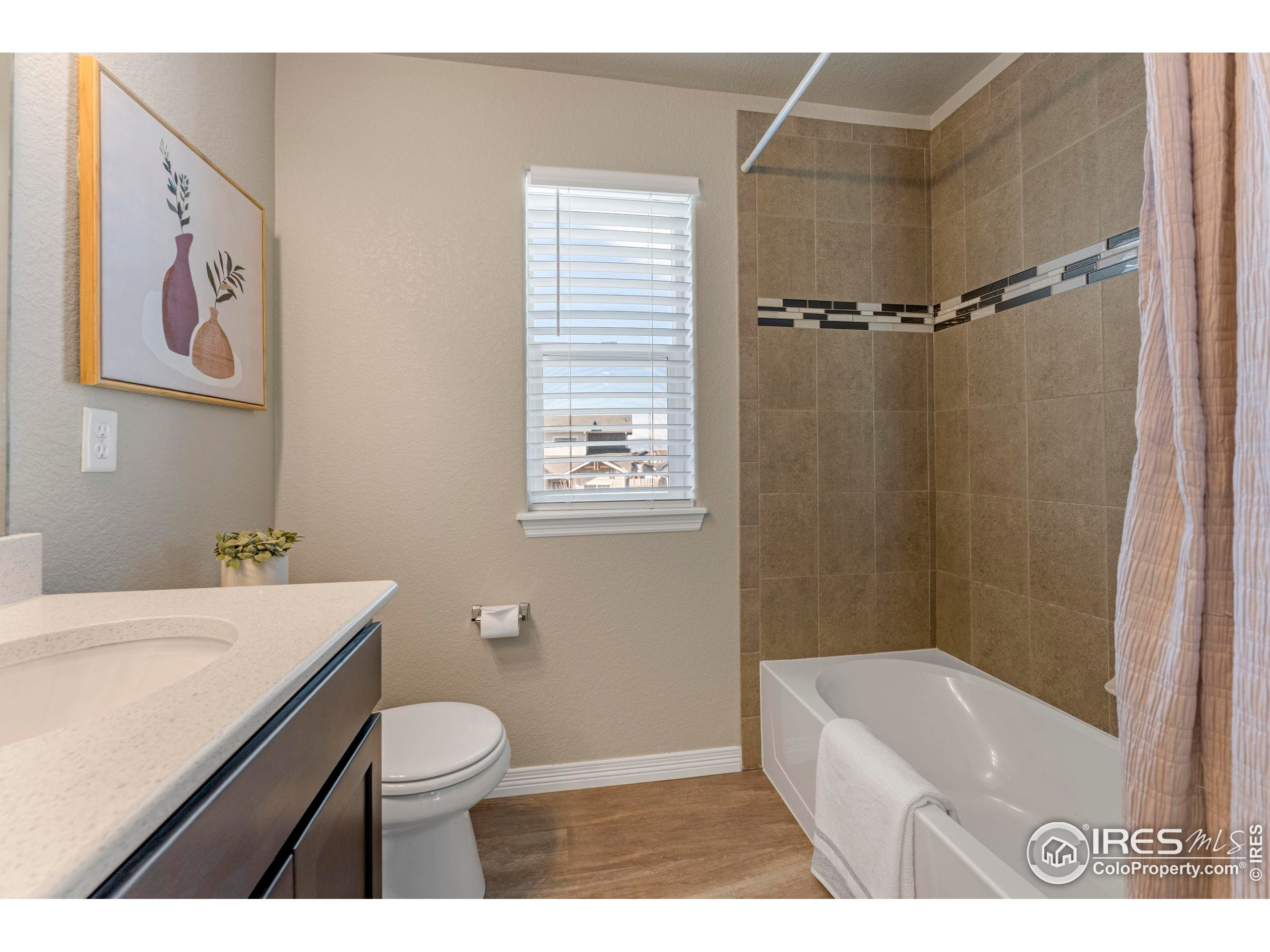 4527 Longmead Drive Windsor, CO 80550 - Photo 25 of 32 a bathroom with a sink a toilet and shower