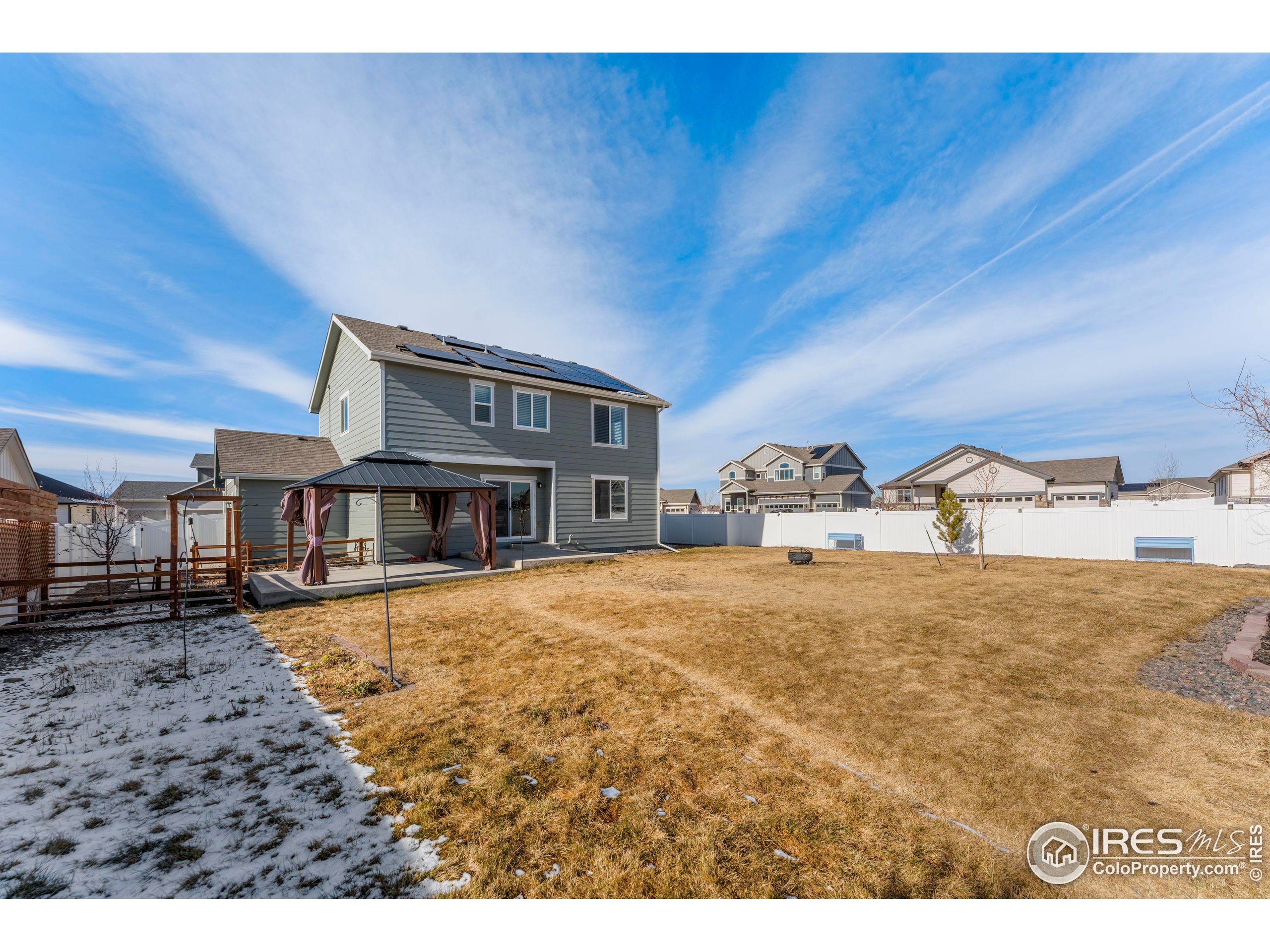4527 Longmead Drive Windsor, CO 80550 - Photo 30 of 32 a bedroom with a bed and a view of kitchen