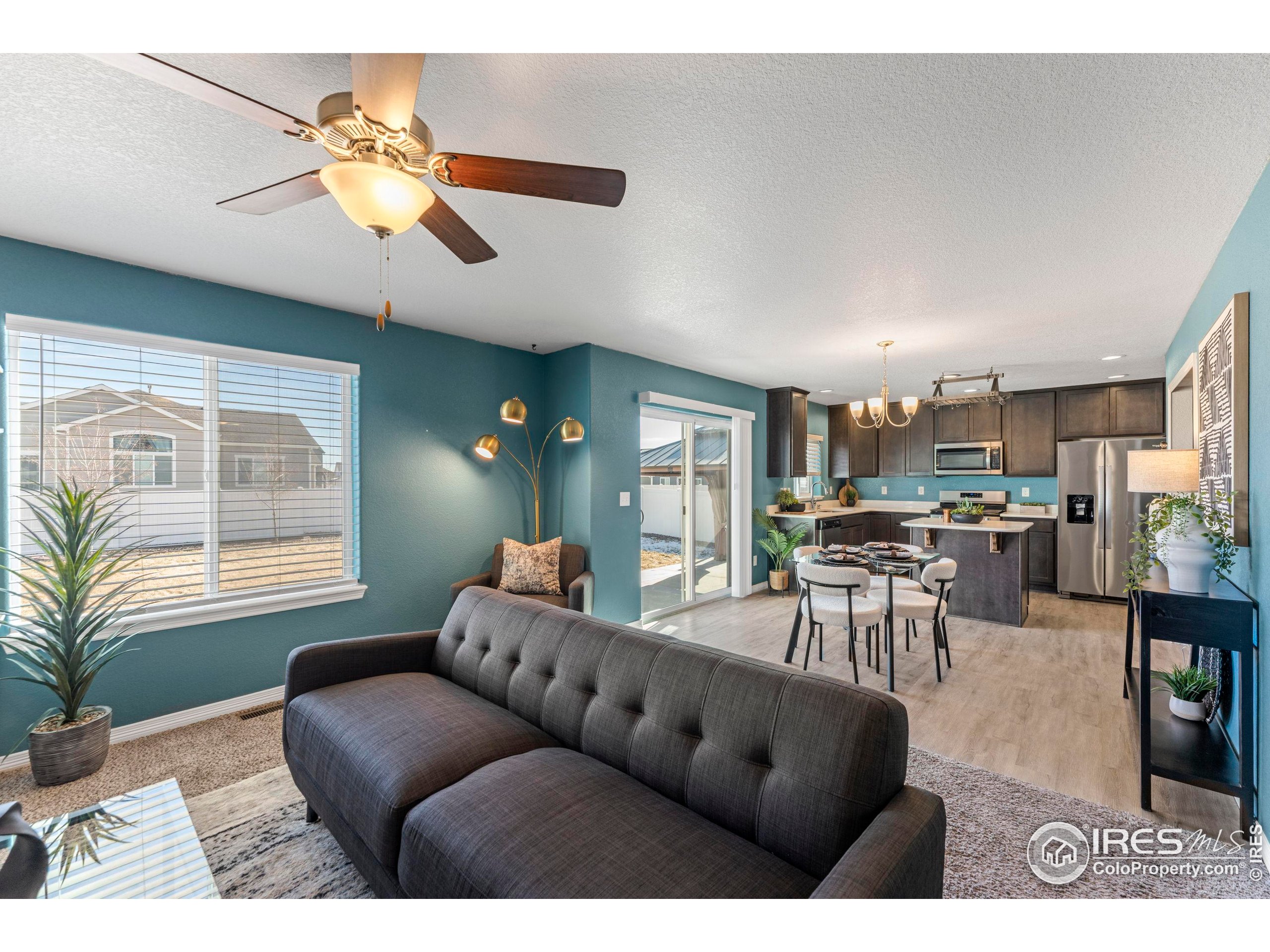 4527 Longmead Drive Windsor, CO 80550 - Photo 5 of 32 a living room with furniture and a large window
