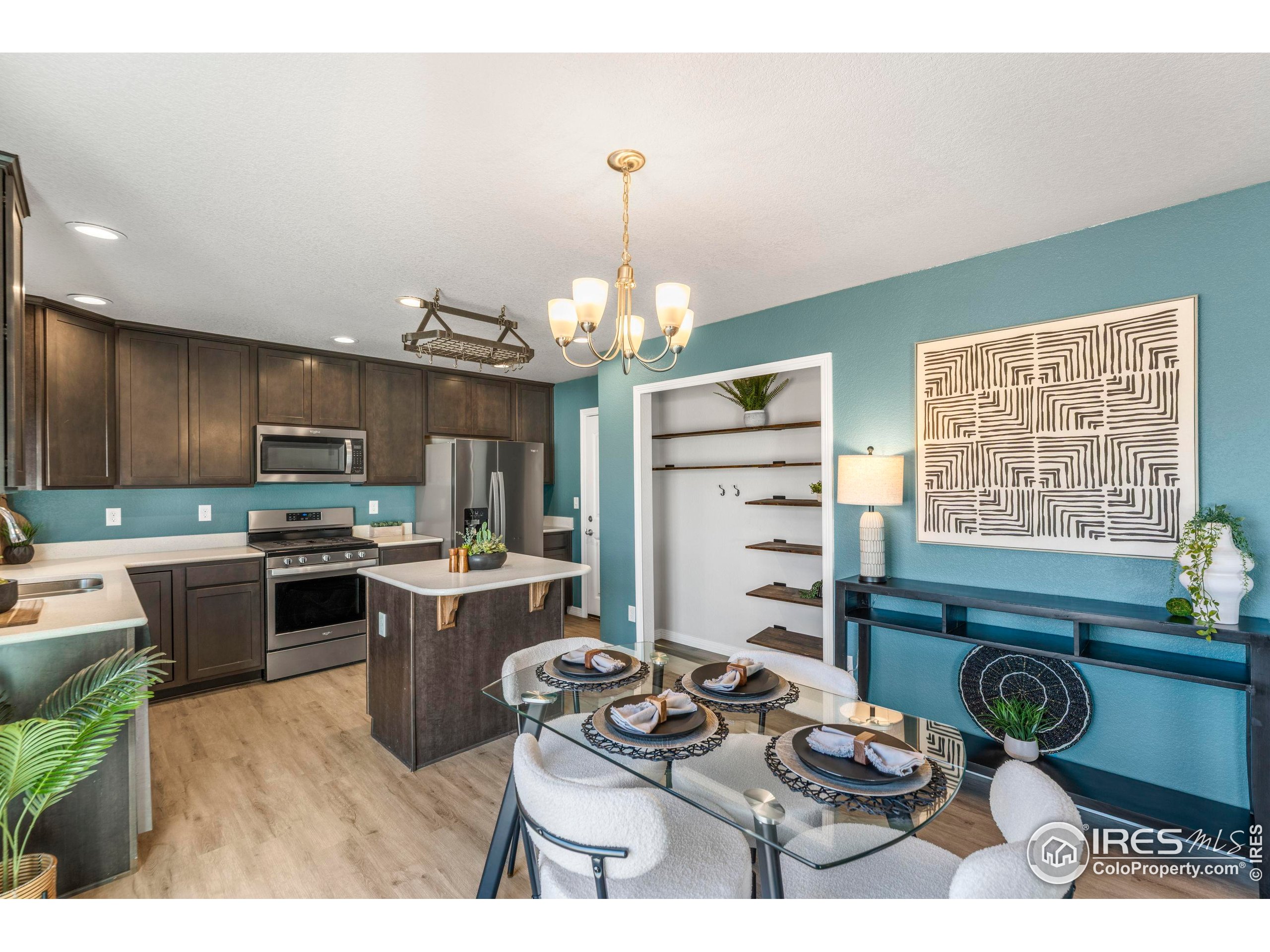 4527 Longmead Drive Windsor, CO 80550 - Photo 8 of 32 a kitchen with a stove and a refrigerator