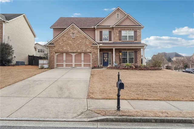 a front view of a house with garden