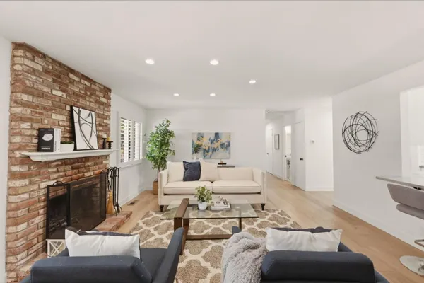 a living room with furniture and a potted plant