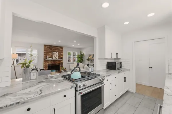 a kitchen with stainless steel appliances a refrigerator sink and cabinets