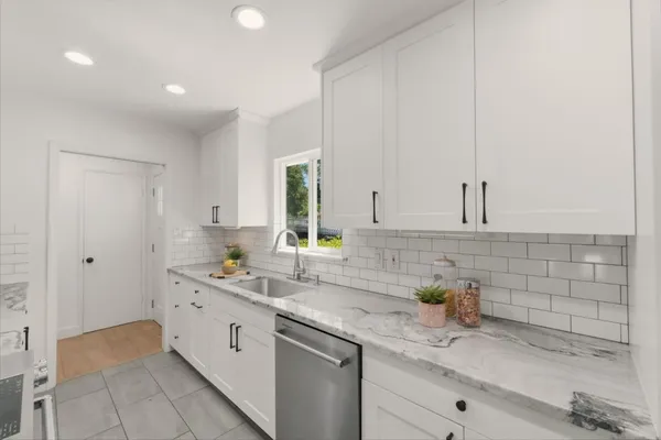 a kitchen with a stove and a granite counter tops