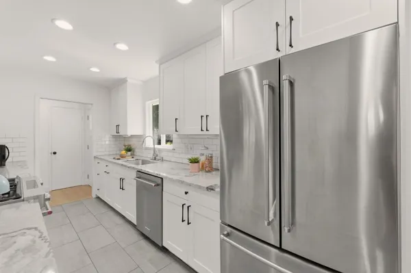 a kitchen with a sink and a stove next to a window