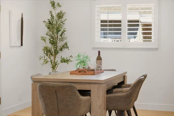 a view of a dining room with furniture and a potted plant